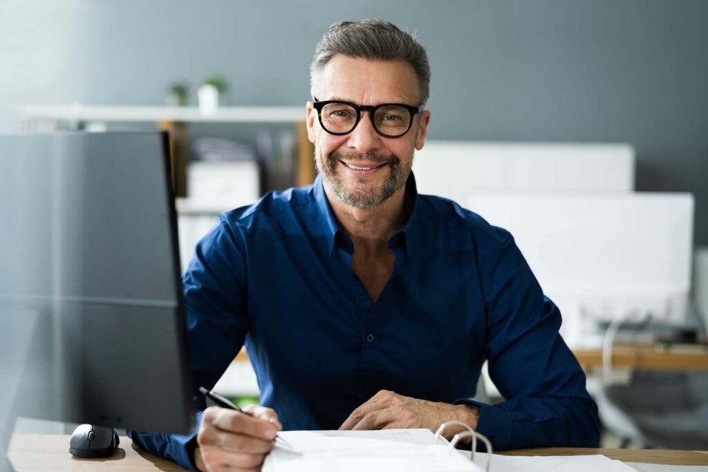 happy accounting man at his desk