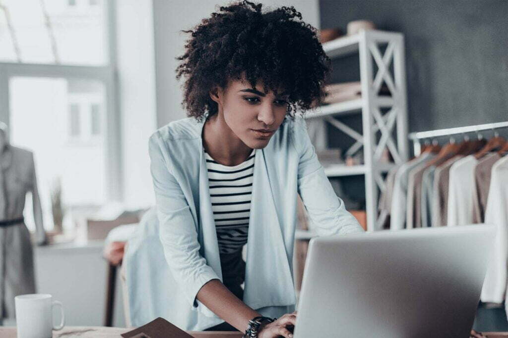 a lady focused on her laptop