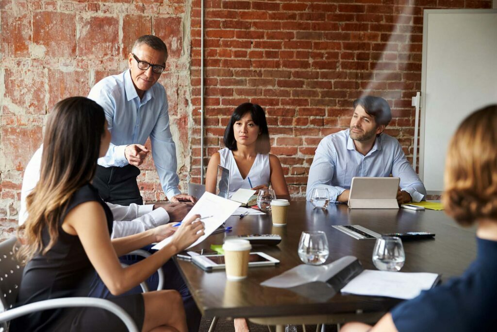 man talking in meeting about new business