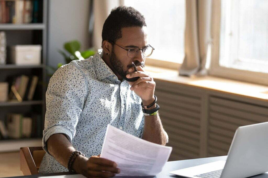 man thinking deeply at about his Flesch-Kincaid levels at computer