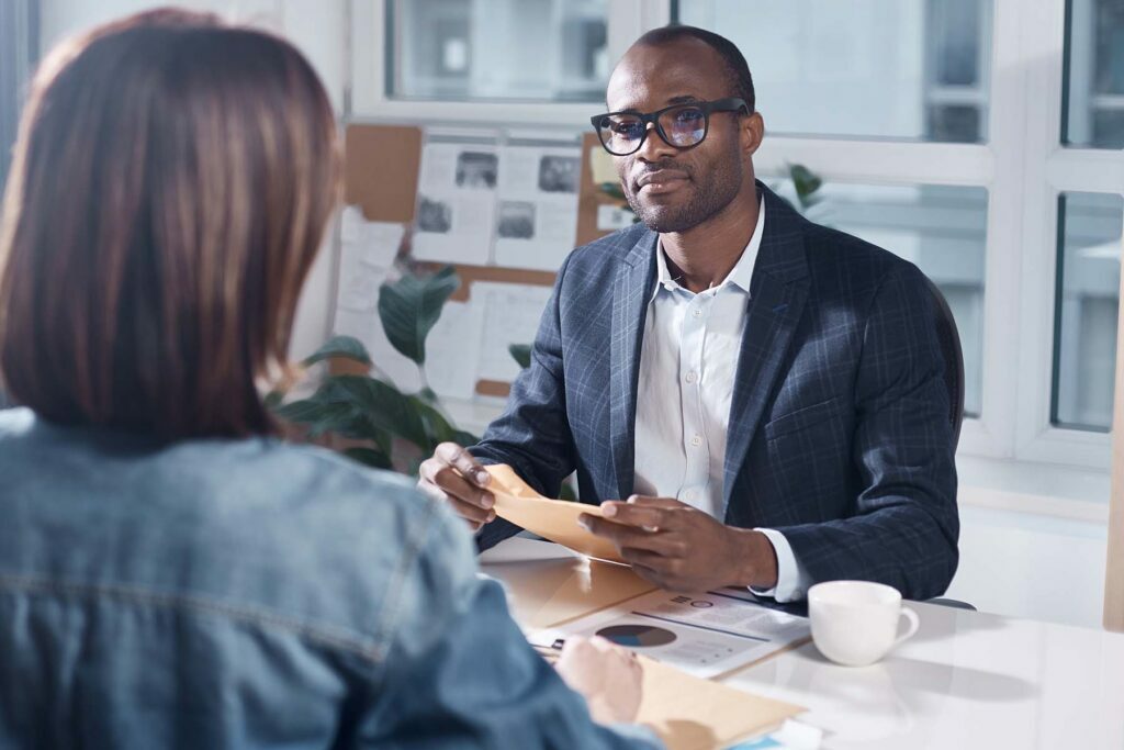 man talking with employee across table
