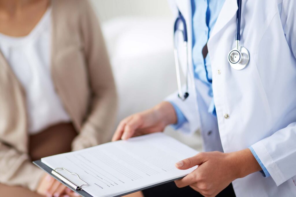 doctor with paperwork for patient about their HSAs