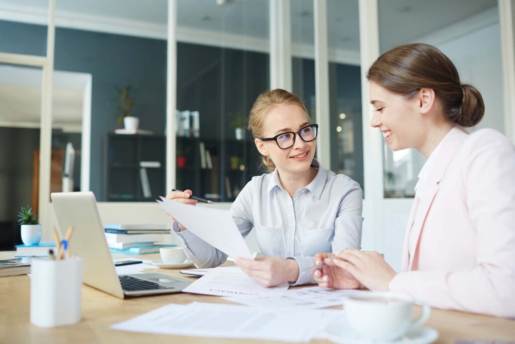 two happy accountant workers talking