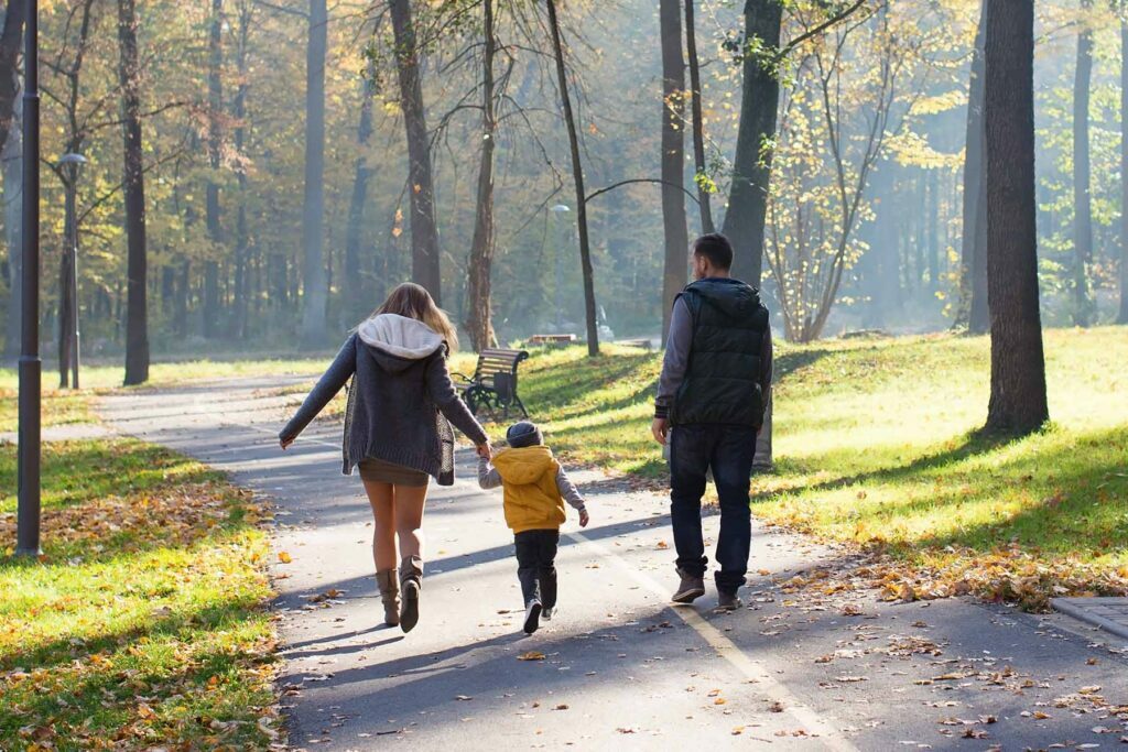 family walking at park to keep in touch