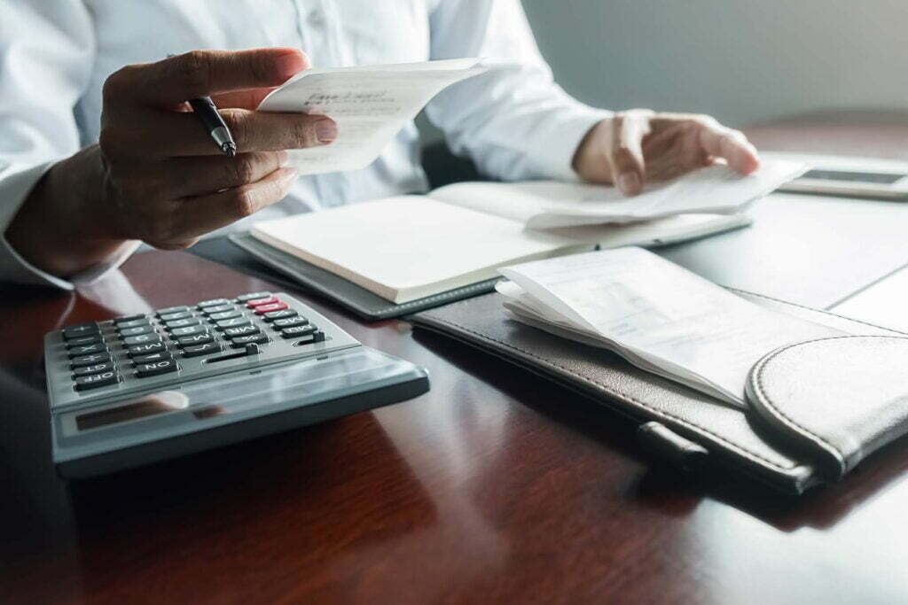 person at desk going over tax calendar
