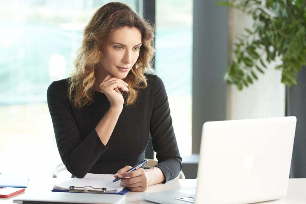 small business owner with notepad on computer