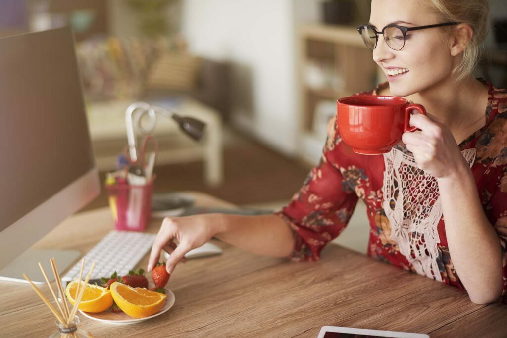 happy lady eating fruit for her morning routine