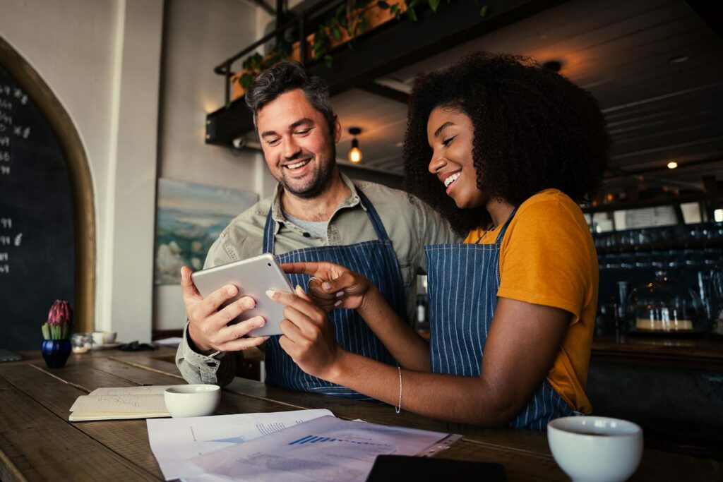 two small business owners going over papers