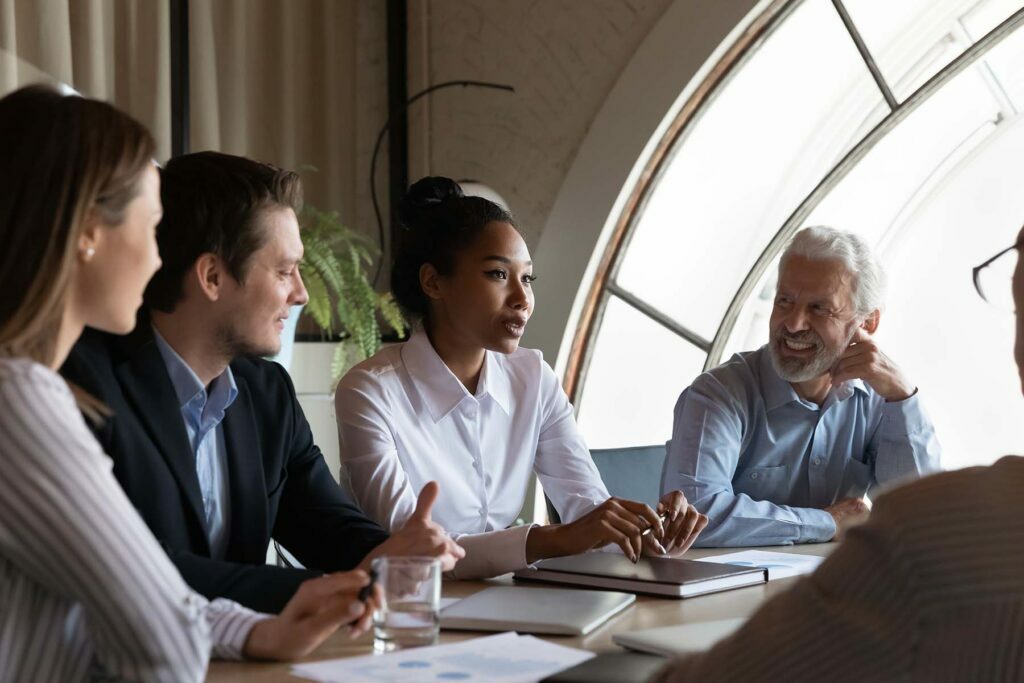sales force talking at a meeting table