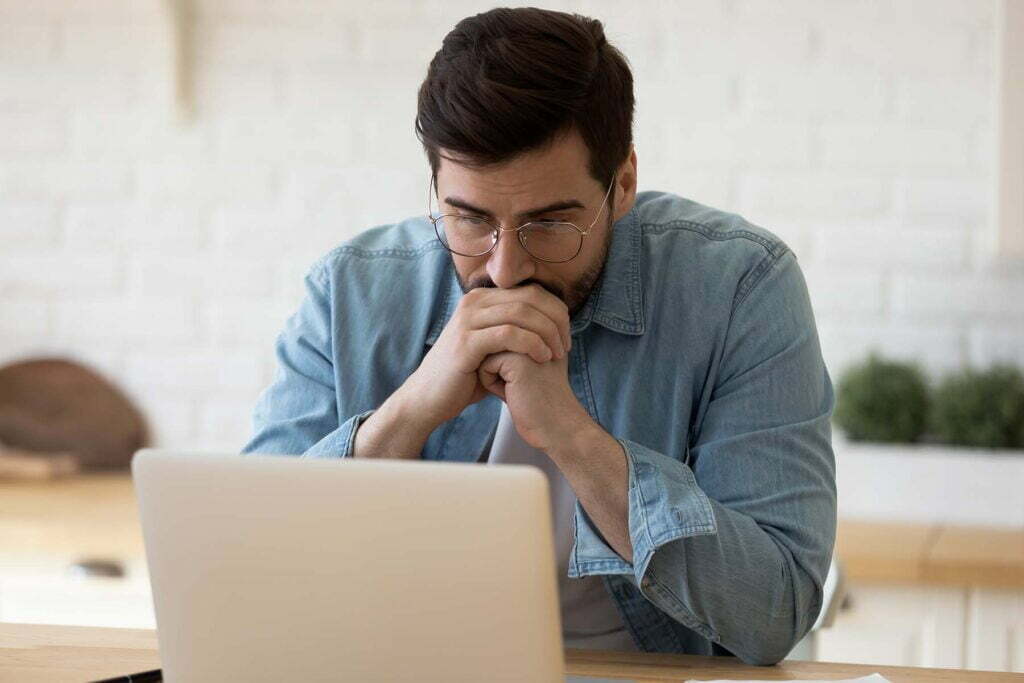 a man worried on his computer over ransomware