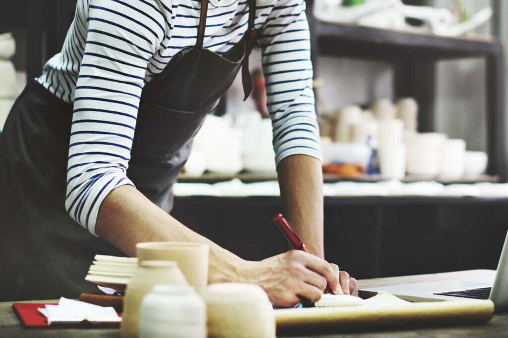 small business owner writing things down about grants