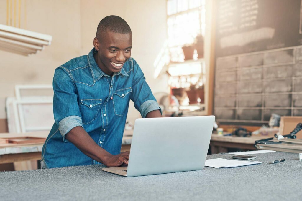 happy man on his laptop looking at tax refund
