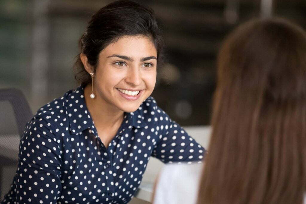 happy lady talking about tax with person