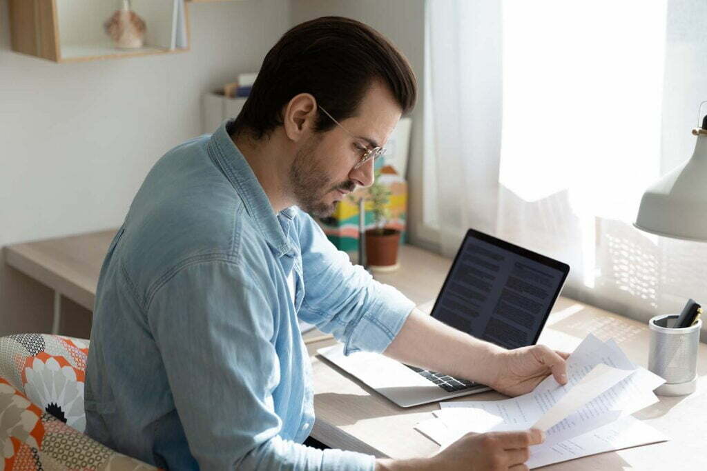 man going over tax help papers