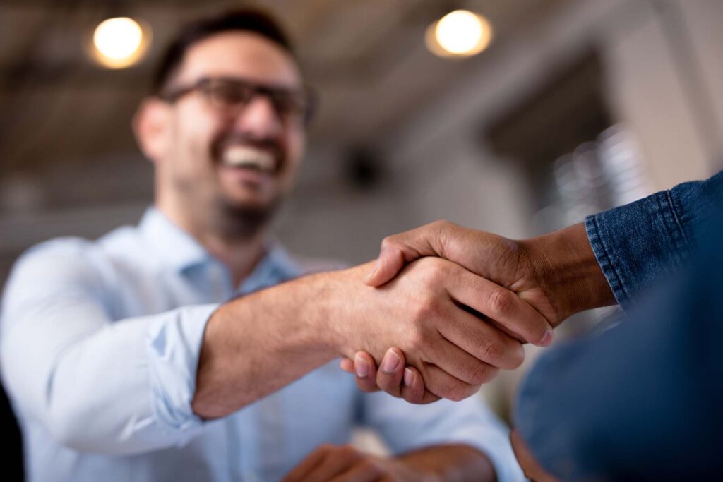happy men shaking hands on bartering