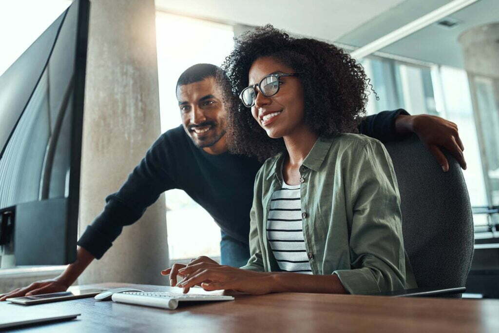 two coworkers at a computer