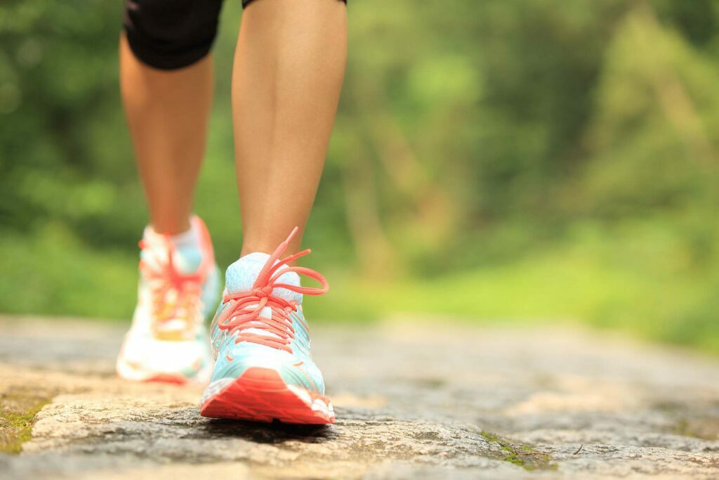 a pair of legs with running shoes on to stay healthy