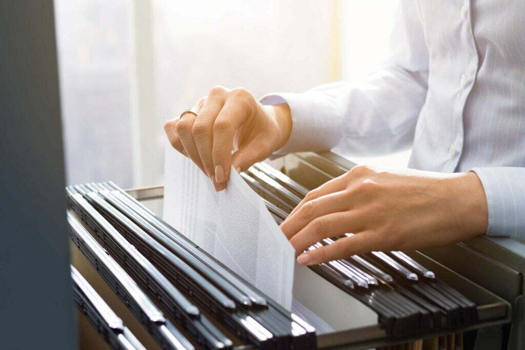 a person filing tax deduction documents away