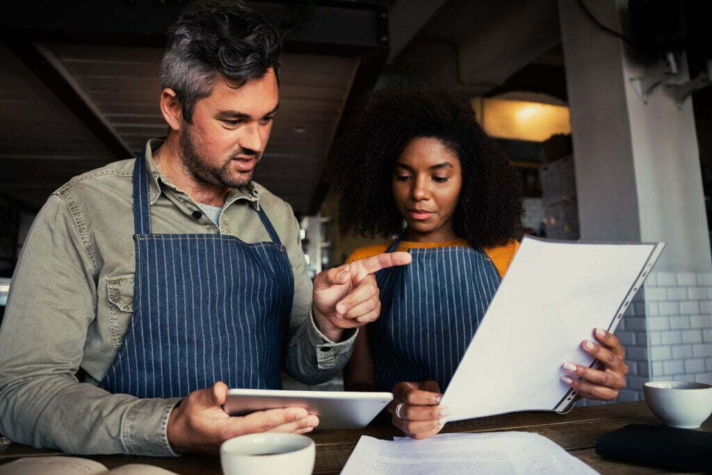 small business owners going over payroll taxes