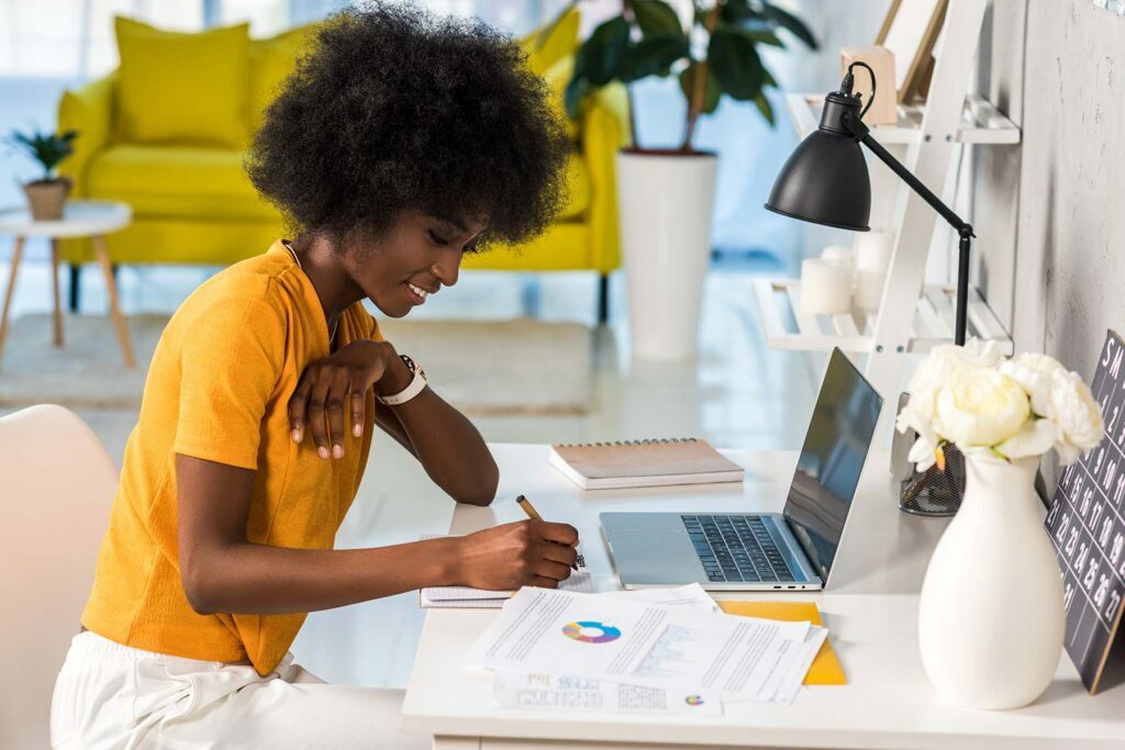 lady in yellow shirt at her work from home desk