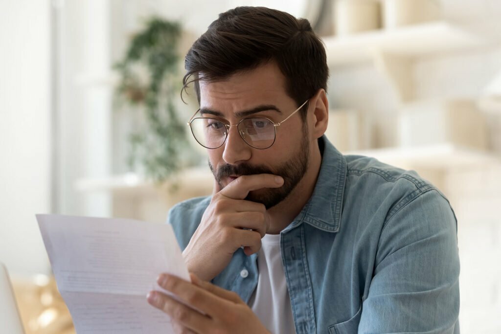 Concerned man looking over IRS papers